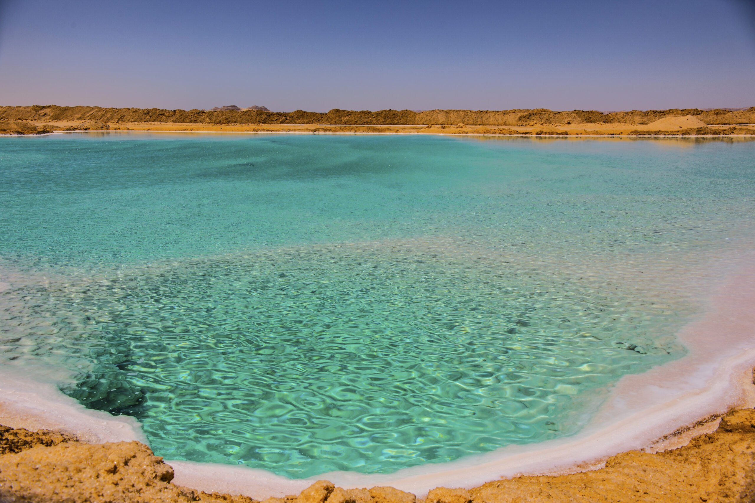 salt-lake-with-turquoise-water-white-salt-shore-near-siwa-oasis-egypt