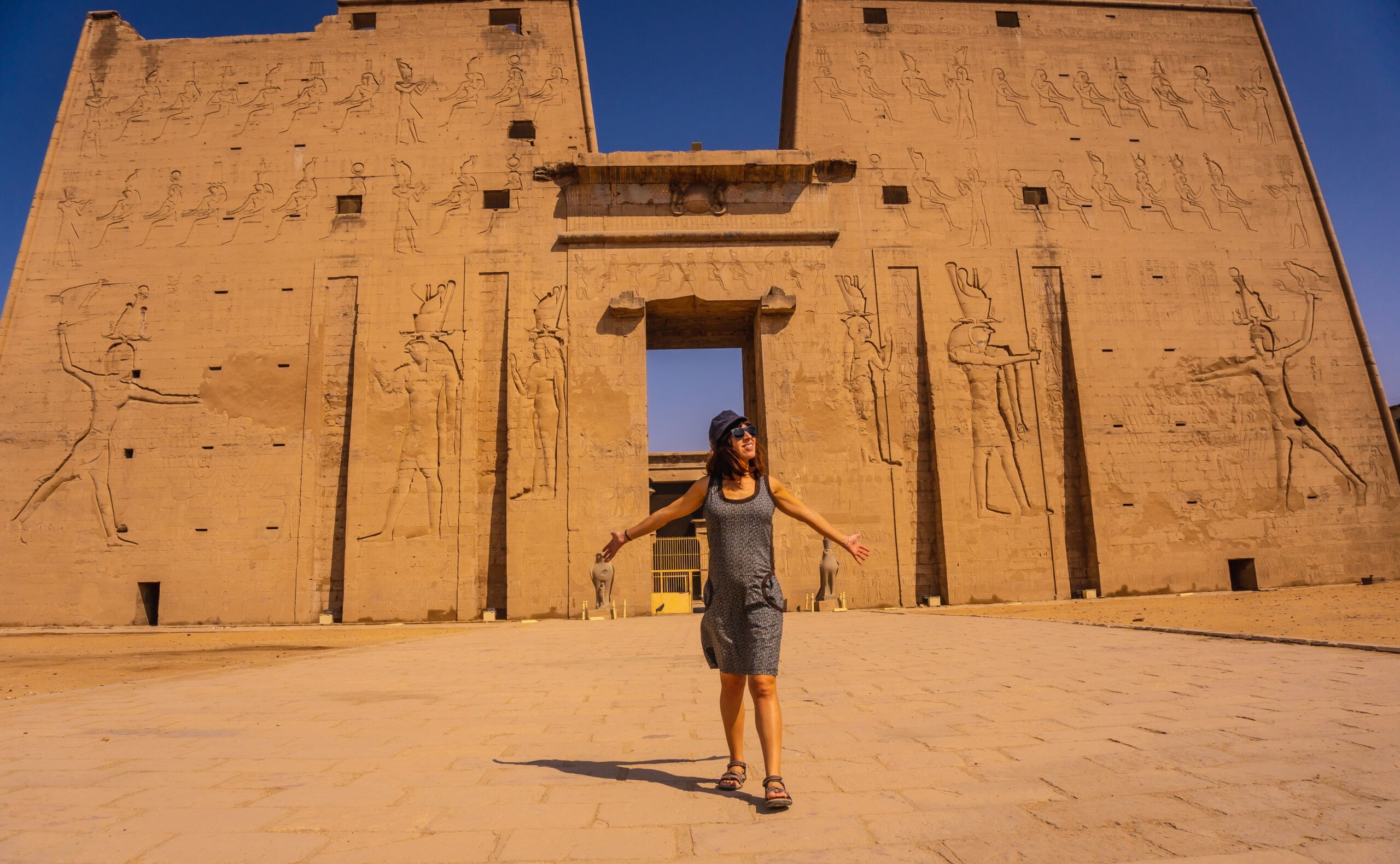 A,Young,Tourist,At,The,Entrance,To,The,Edfu,Temple